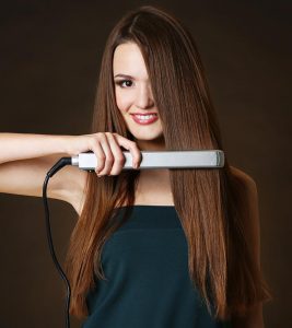 Sad, face portrait and woman with hair straightener in studio isolated on  gray background. Haircare damage, hairloss and black female model angry  with flat iron for hairstyle after salon treatment. | Buy