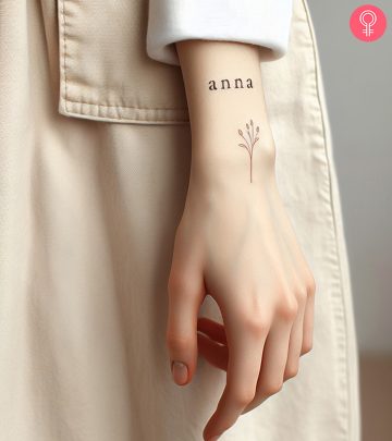 Name tattoo design on a woman’s forearm
