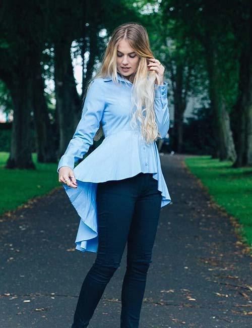 Beautiful brunette young woman wearing black jeans, white shirt and walking  on the street . Fashion magazine in hand. Blurred background. Stock Photo |  Adobe Stock