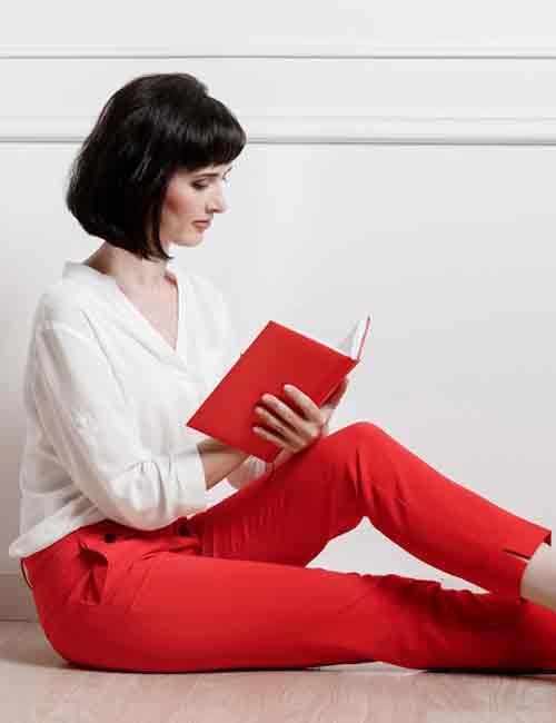 A Pretty Woman Wearing Green Blouse and Red Pants with Black Boots · Free  Stock Photo