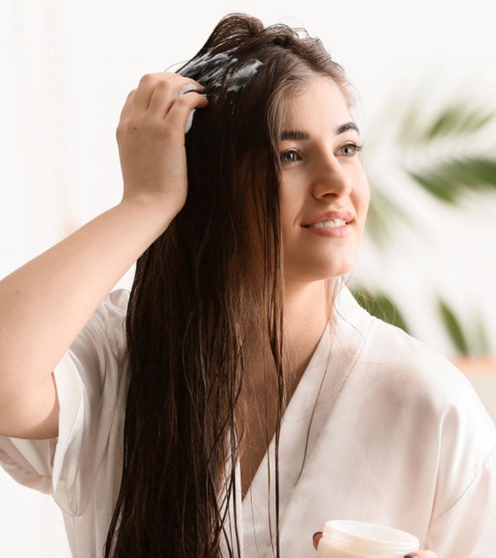 Woman Applying Shea Butter To Her Hair