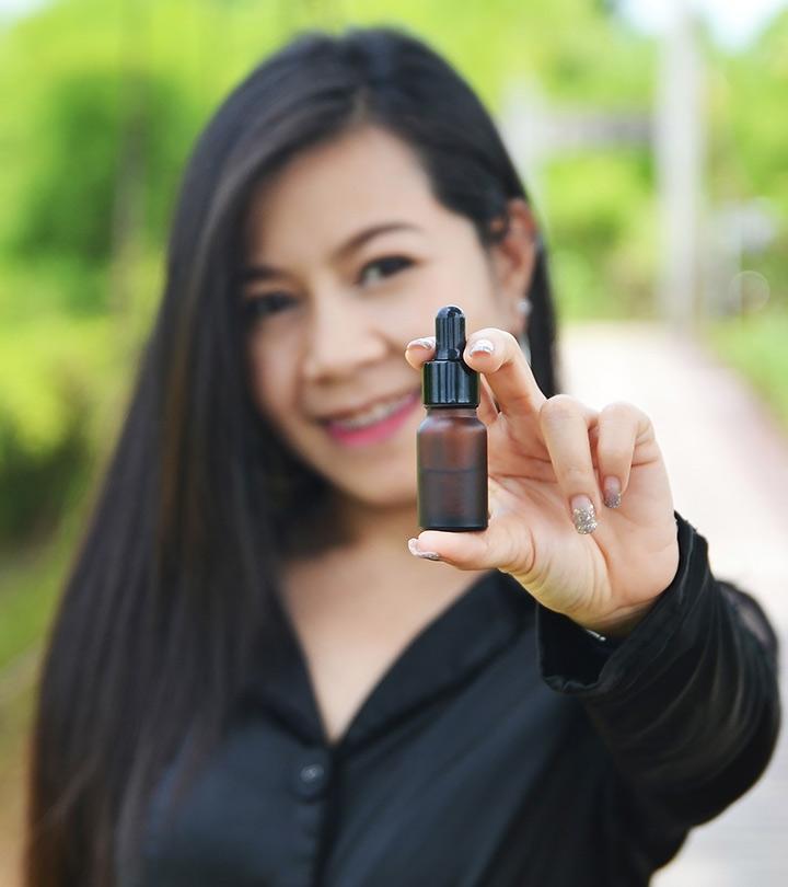 A girl showing a niacinamide bottle