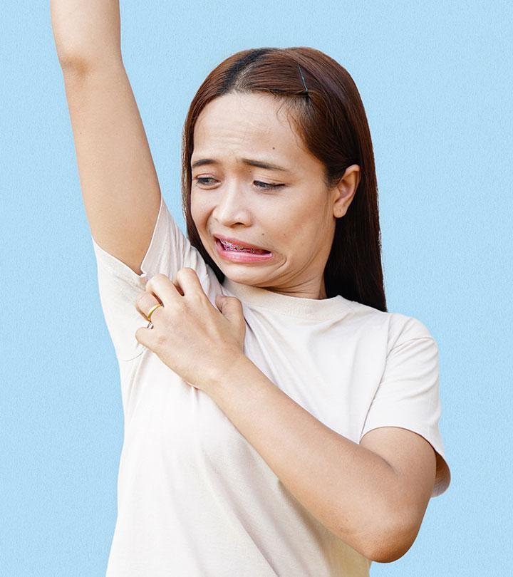 A girl scratching her underarm