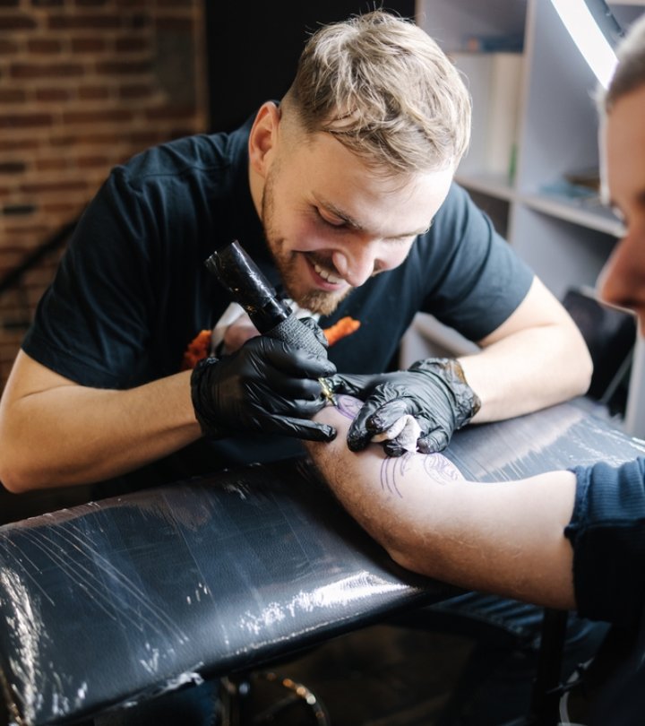 Tattoo artist drawing a tattoo on the wrist