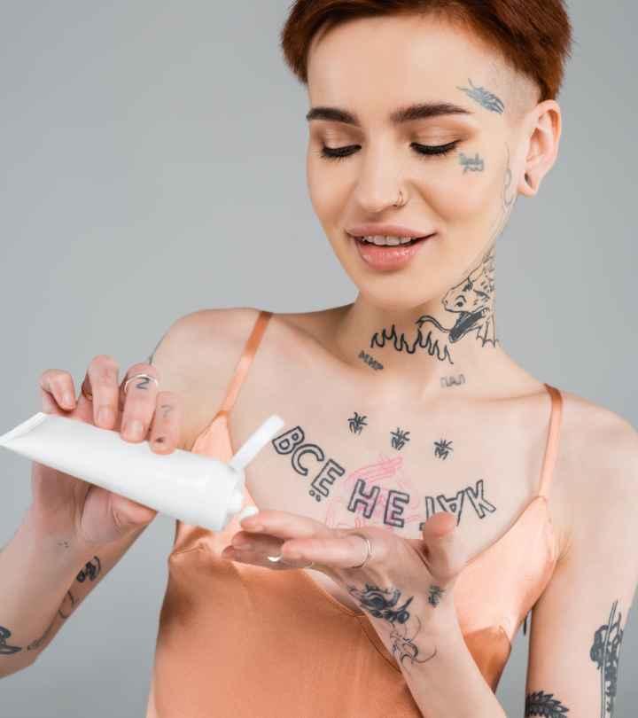 Woman with tattoos using Neosporin