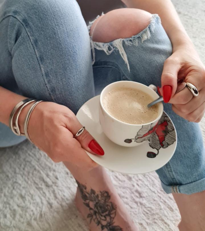 Girl with a tattoo on her foot having coffee