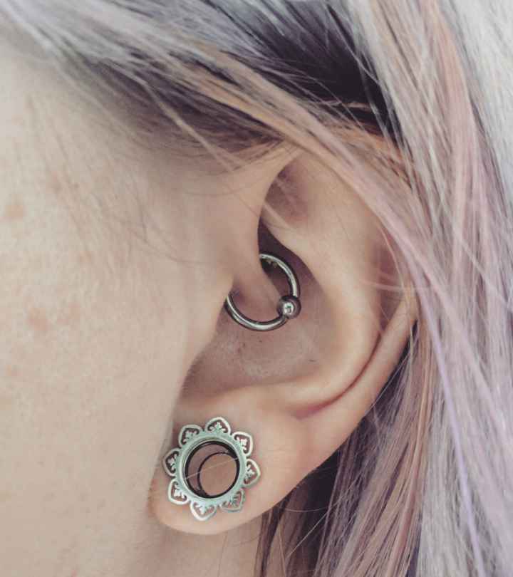 A woman’s ear with a daith piercing for migraines