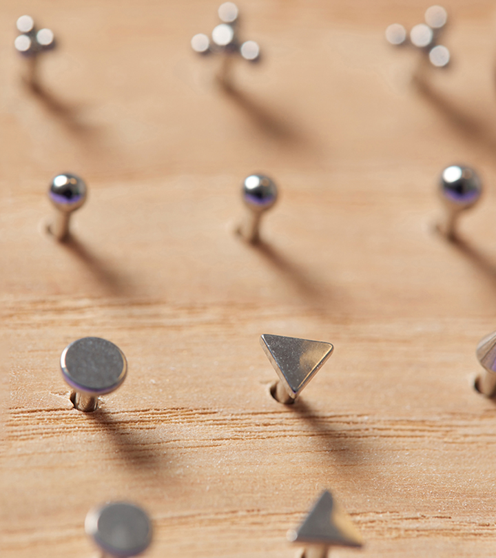 Piercing jewelry set on a wooden board