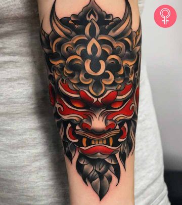 A woman with a Oni mask tattoo on her arm