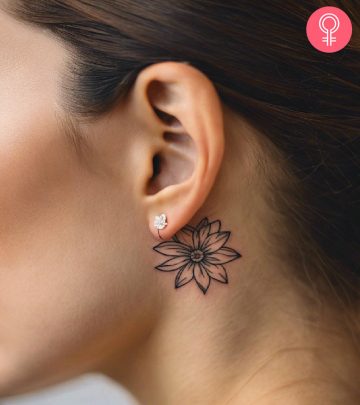 A pretty flower tattoo on the back of the ear