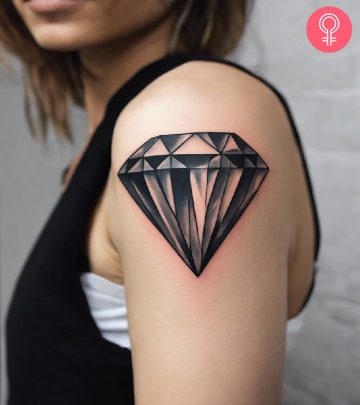 A woman with a diamond tattoo on her upper arm