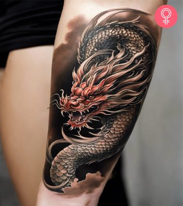 Golden Chinese dragon tattoo on the arm