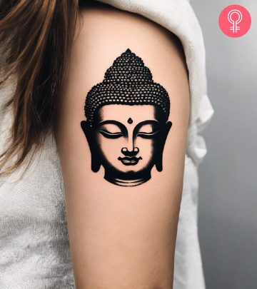 Spiritual lotus tattoo on the upper arm of a woman