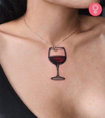 A woman with a wine glass tattoo inked on her chest A woman with a wine glass tattoo inked on her chest