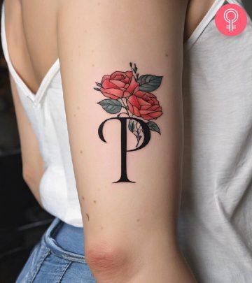 Stylized P tattoo on the upper arm