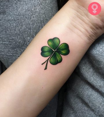 A four-leaf clover good luck tattoo on the arm