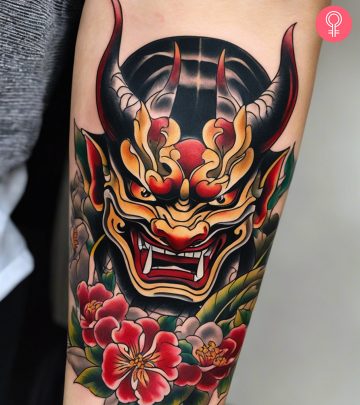 A hannya mask tattoo on the forearm