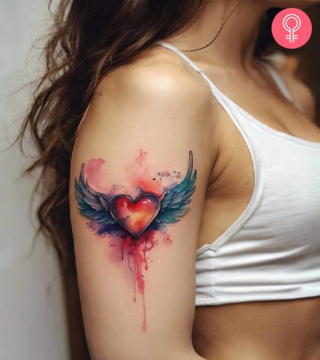 A heart with wings tattoo on the upper arm