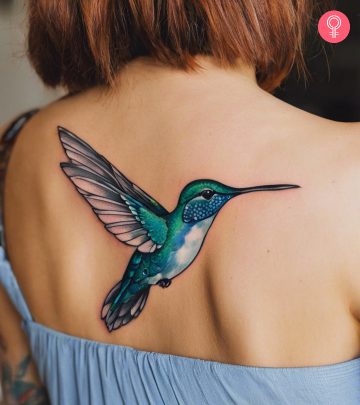 A hummingbird tattoo on a woman’s back