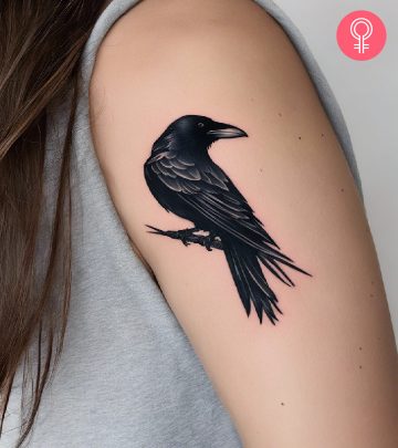 A raven tattoo on the upper arm