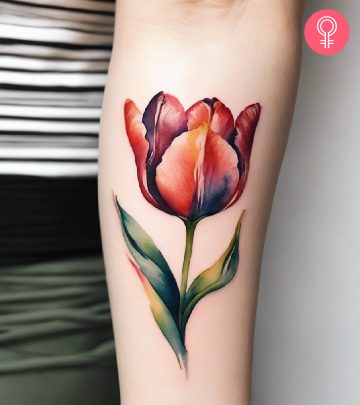 A woman sporting a tulip tattoo on the forearm