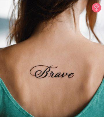 A woman with Brave inked on the back of her shoulder