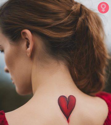 A woman with a broken heart tattoo on her upper back A woman with a broken heart tattoo on her upper back