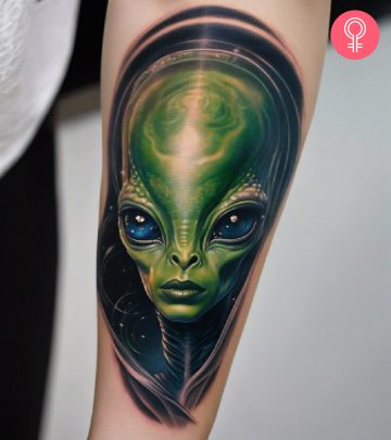 A woman with a green alien tattoo on her arm