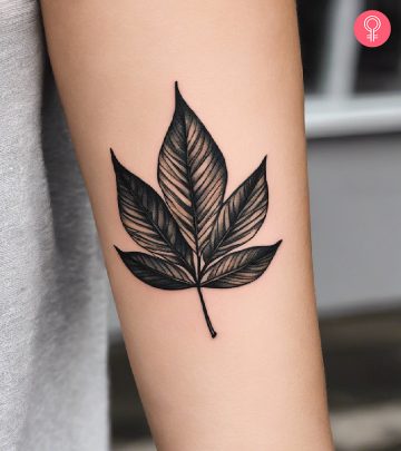 A woman with a leaf tattoo on her arm