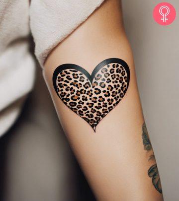A woman with a leopard print heart tattoo on the upper arm A woman with a leopard print heart tattoo on the upper arm