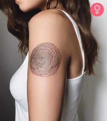 A woman with a spiral tattoo on the upper arm