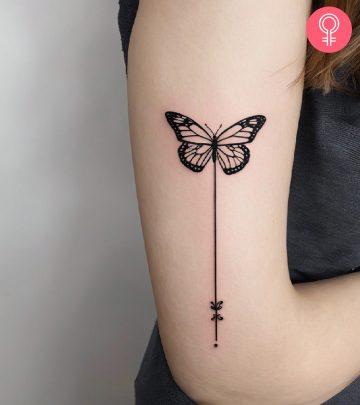 A woman with a stick and poke tattoo on her shoulder A woman with a stick and poke tattoo on her shoulder