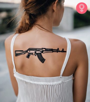 A woman with an AK-47 tattoo on her upper back