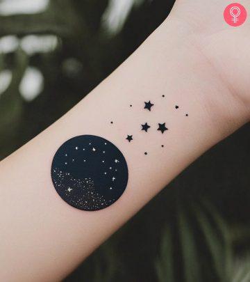 A woman with night sky tattoo on her wrist