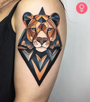 An upper arm lioness tattoo