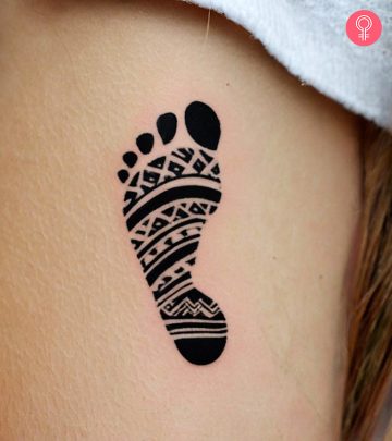 Baby footprint tattoo on a woman’s arm