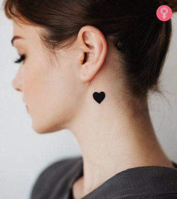Woman with a black heart tattoo on the neck