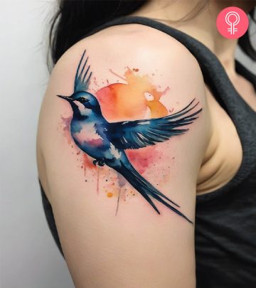 swallow tattoo on the upper arm