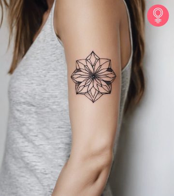 A woman with a geometric flower tattoo on her arm
