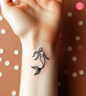 Woman with mermaid tattoo on her wrist
