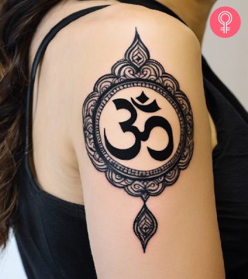 a woman with a Hindu om tattoo on her upper arm