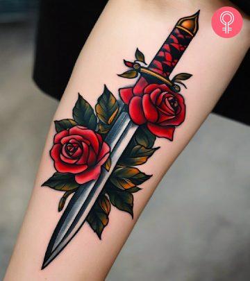 A woman with a rose and dagger tattoo on her arm