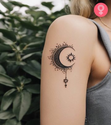 A sun and moon tattoo on the upper arm