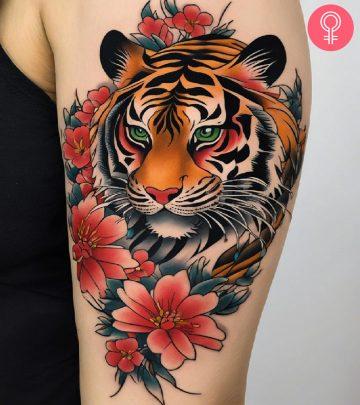 A woman with a Japanese tiger tattoo on her upper arm A woman with a Japanese tiger tattoo on her upper arm