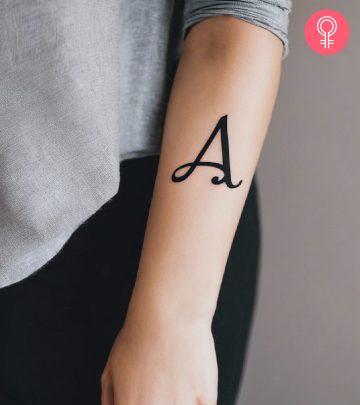 A woman with a letter A tattoo design on the arm A woman with a letter A tattoo design on the arm