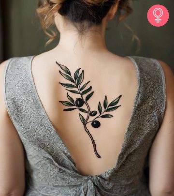 A woman with an olive branch tattoo on her back
