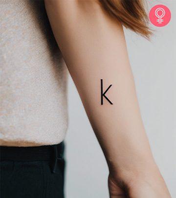 Letter K written in bold on the forearm Letter K written in bold on the forearm