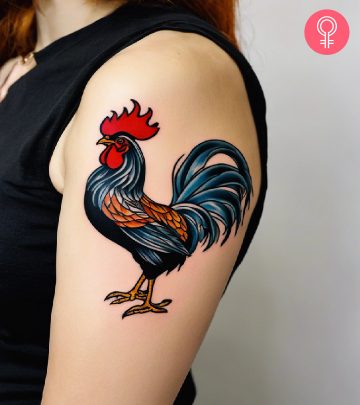 Traditional rooster tattoo on the upper arm