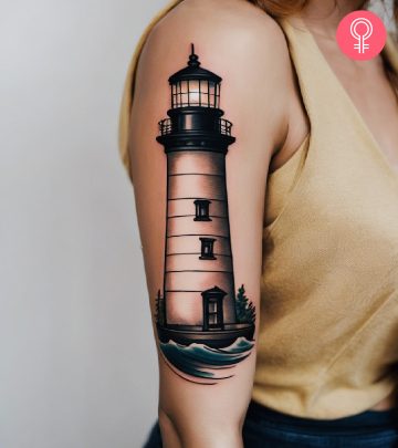 Woman with a lighthouse tattoo on her upper arm