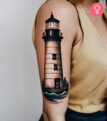 Woman with a lighthouse tattoo on her upper arm Woman with a lighthouse tattoo on her upper arm